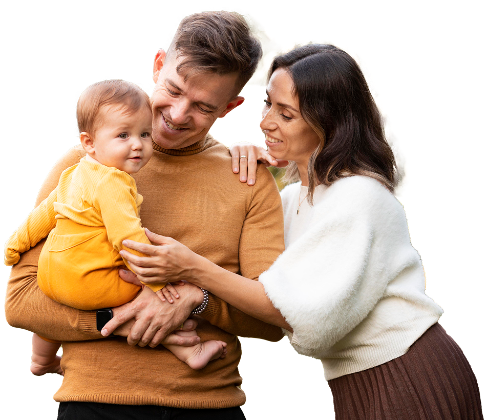 Smiling parents holding their toddler at Windmill Practice.