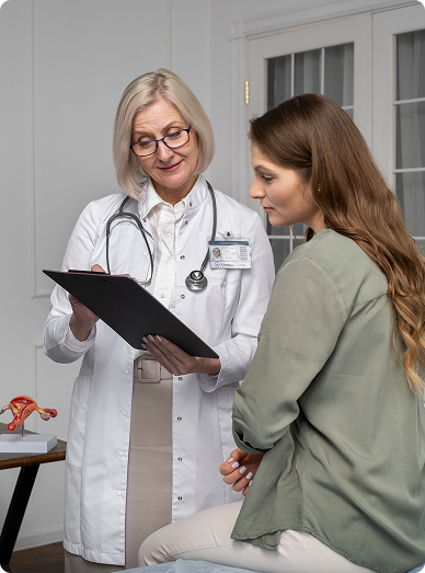 Female doctor discussing notes with a woman during a women’s health consultation at Windmill Practice.